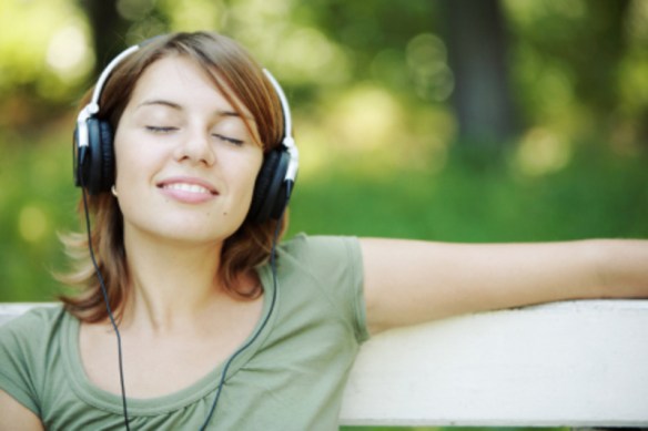 Relaxed young woman listening woman in park